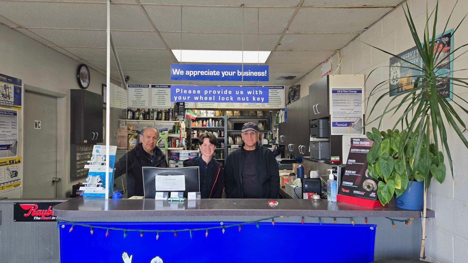 The Imperial Street Auto Repair team at the service counter in Burnaby